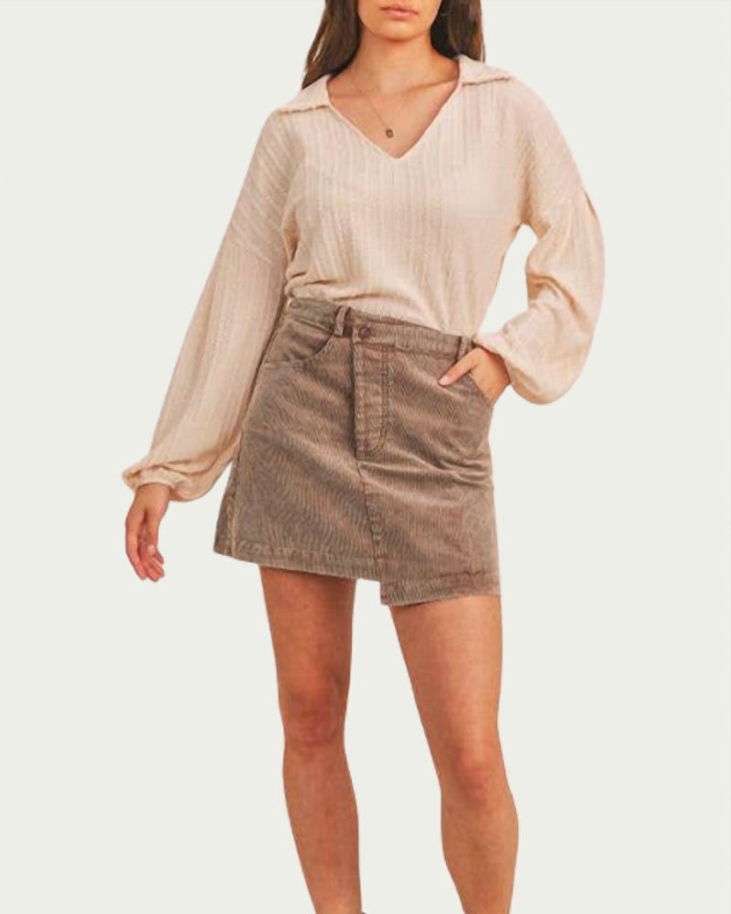 Front of a model wearing a size L Criss-Cross Asymmetrical Corduroy Skirt in Washed Mocha in Washed Mocha by Sadie & Sage. | dia_product_style_image_id:338612